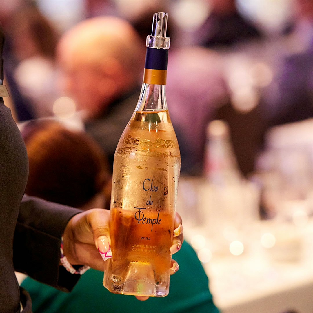 A bottle of Gérard Bertrand Languedoc-Cabrières Rosé Clos du Temple 2022 held by a Wine Experience staff member